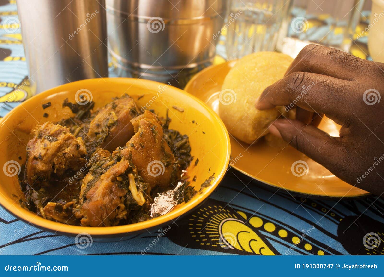 eating a yummy meal of nigerian garri or eba and vegetable soup