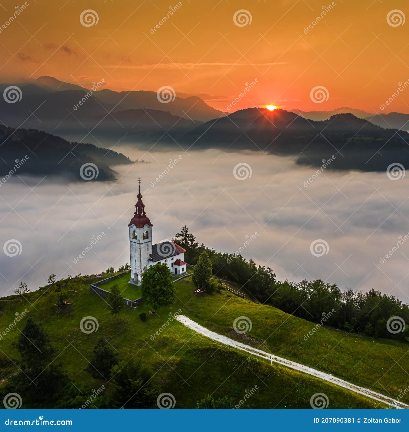 ÃÂ ebrelje, slovenia - aerial drone view of the beautiful hilltop church of st.ivan sv. ivan cerkev at sunrise with morning fog