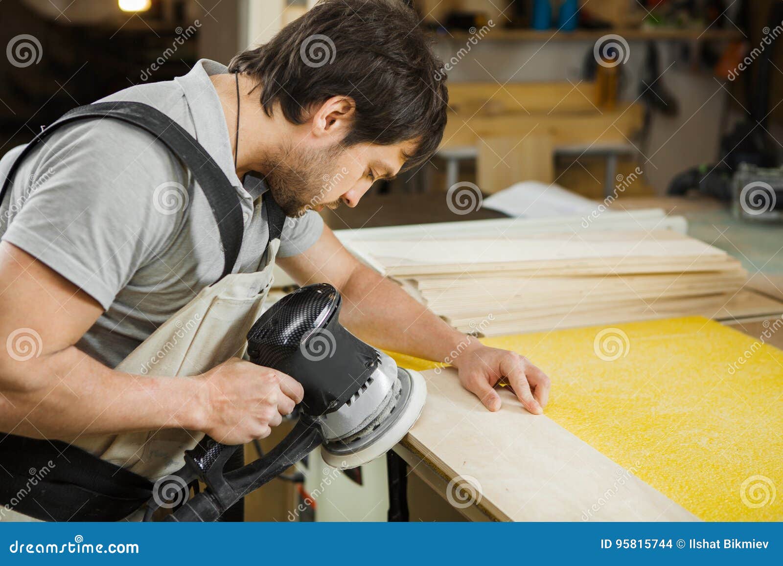 eccentric grinding machine makes wooden polishing of bar plank