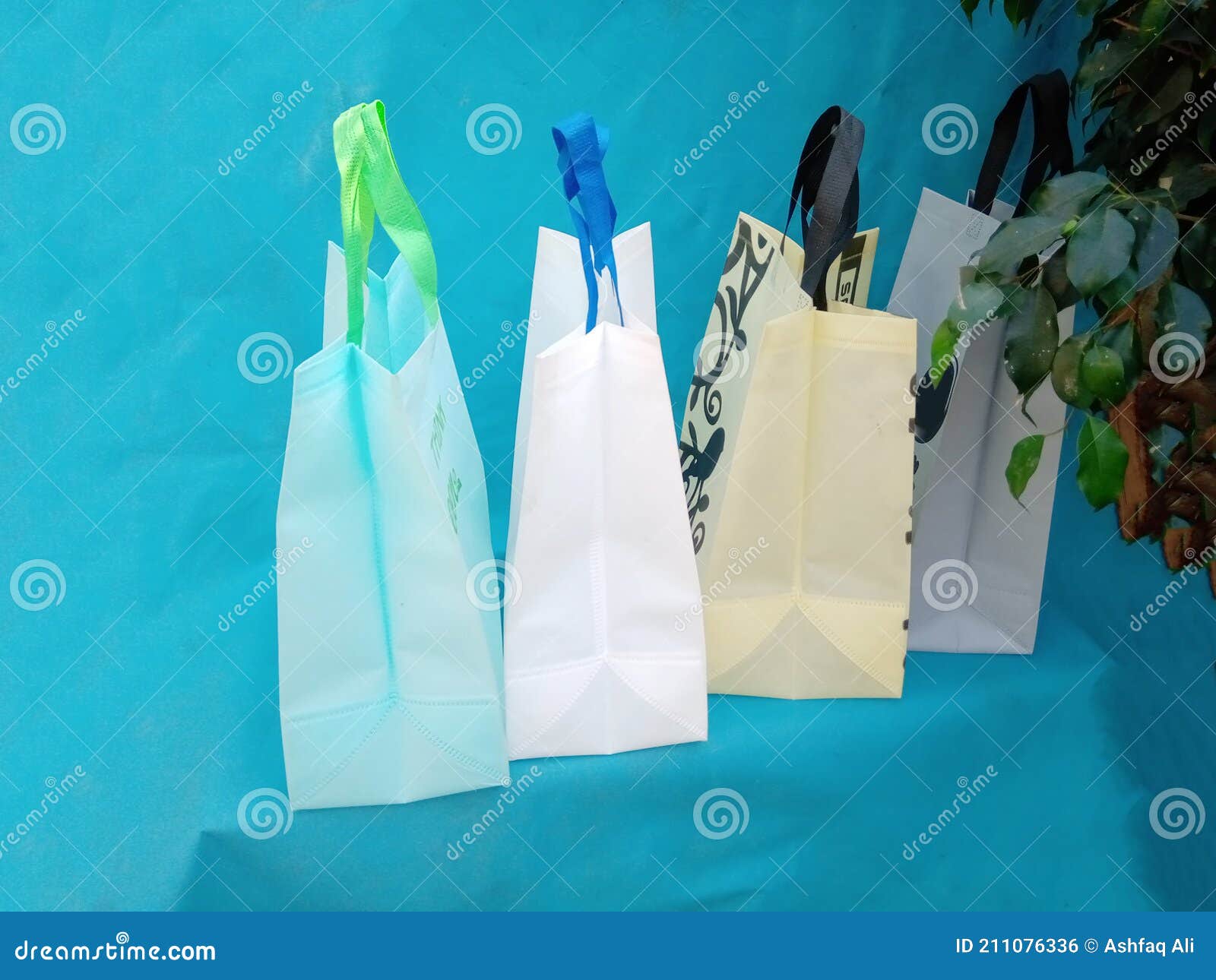 ECO Bags on Blue Background with Green Leaves Stock Photo - Image of ...