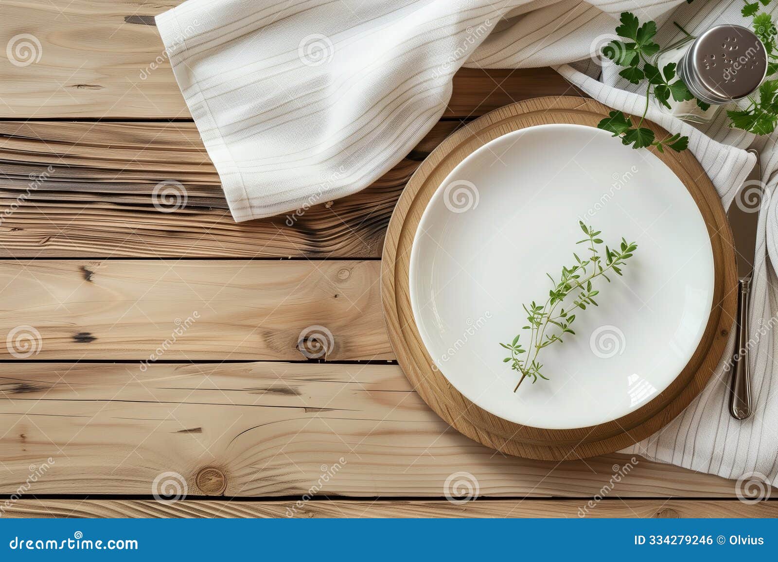 eco-friendly table setting . white plate and linen napkin on a light wooden table. dishes made from environmentally friendly