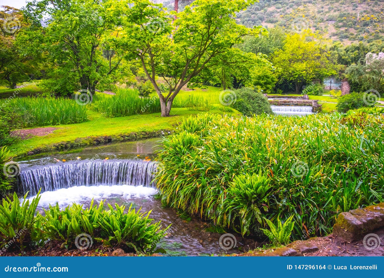eden garden fairytale waterfall fountain in the giardino di ninfa - cisterna di latina - lazio - italy