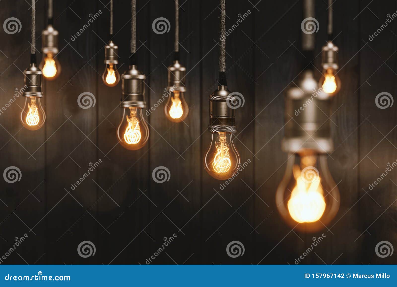 edison light bulbs in front of a wooden wall