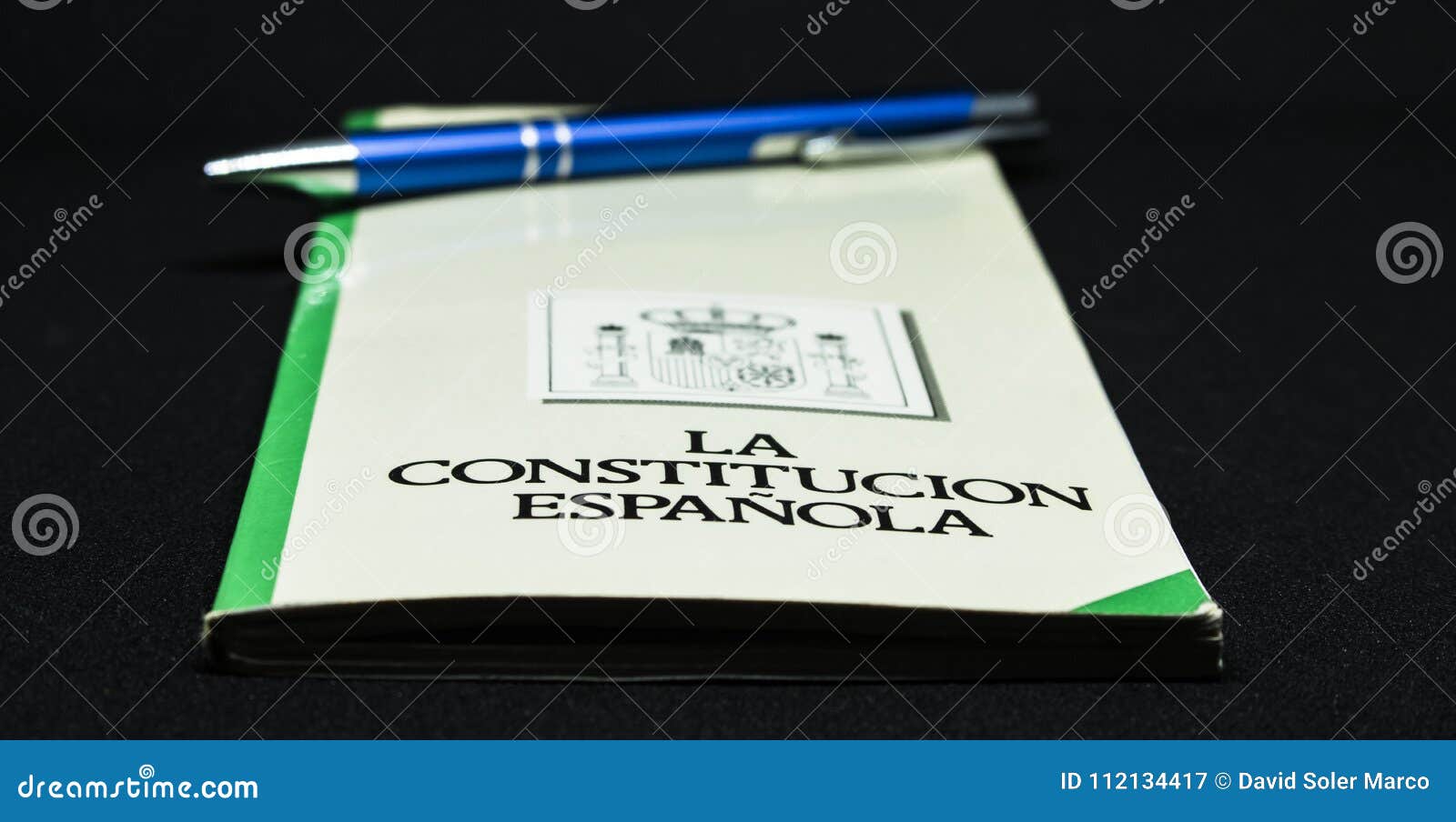 book of the spanish constitution wiht a pen and the graphical white background