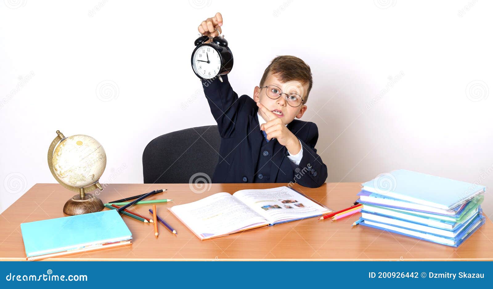 The Student Sits at the Table, Does His Homework and Points To the