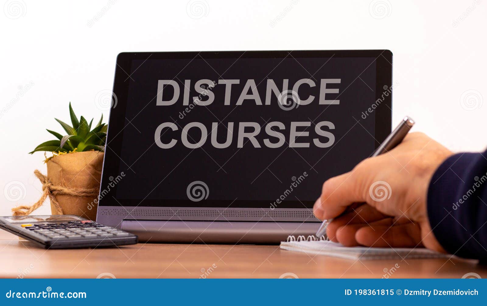 education concept. tablet with text `distance courses`. online education during covid-19 quarantine. male hand with pen,