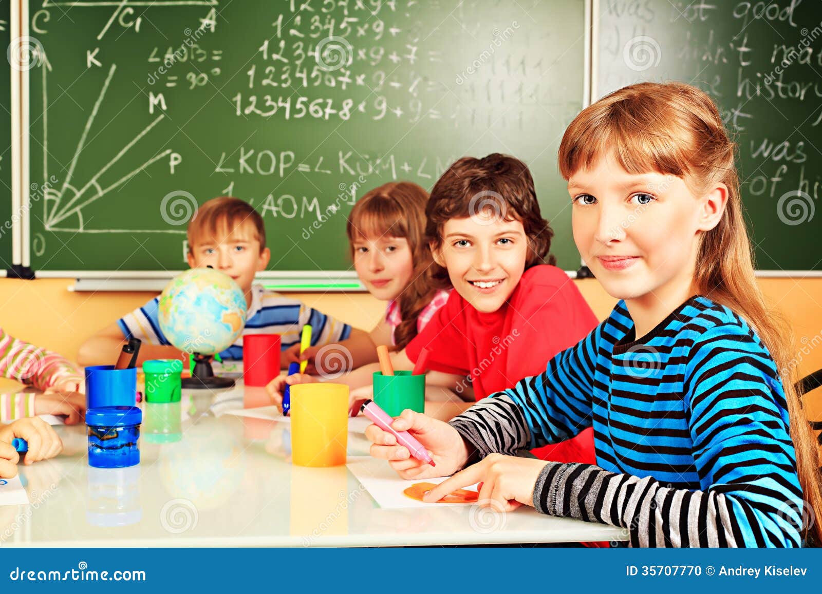 Education. Group of school children studying in classroom.