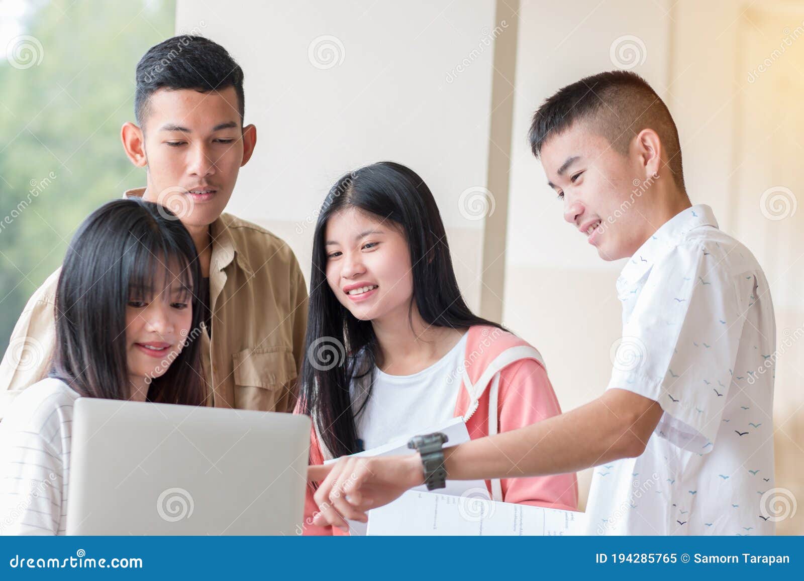 education learning concept : students young  asian college groups using tablet to studying together with documents paper for