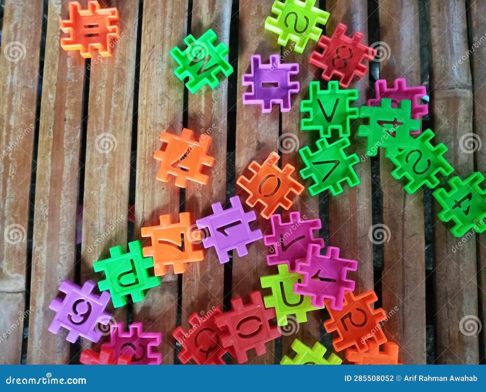 Educational Plastic Puzzle Toy Called Building Blocks on Bamboo Surface ...