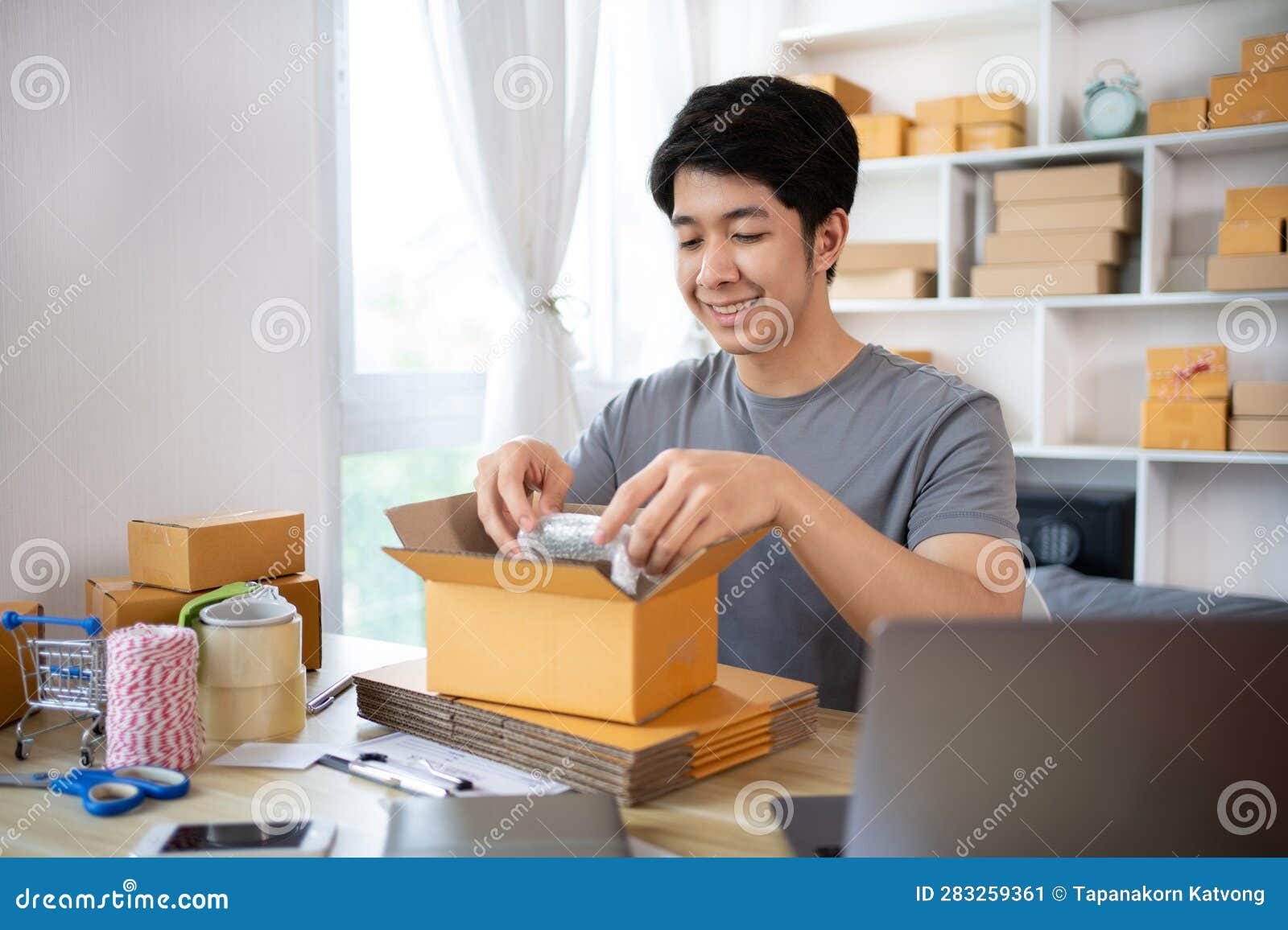 Efficient HomeBased Delivery, Man Packing Items into Post Box for