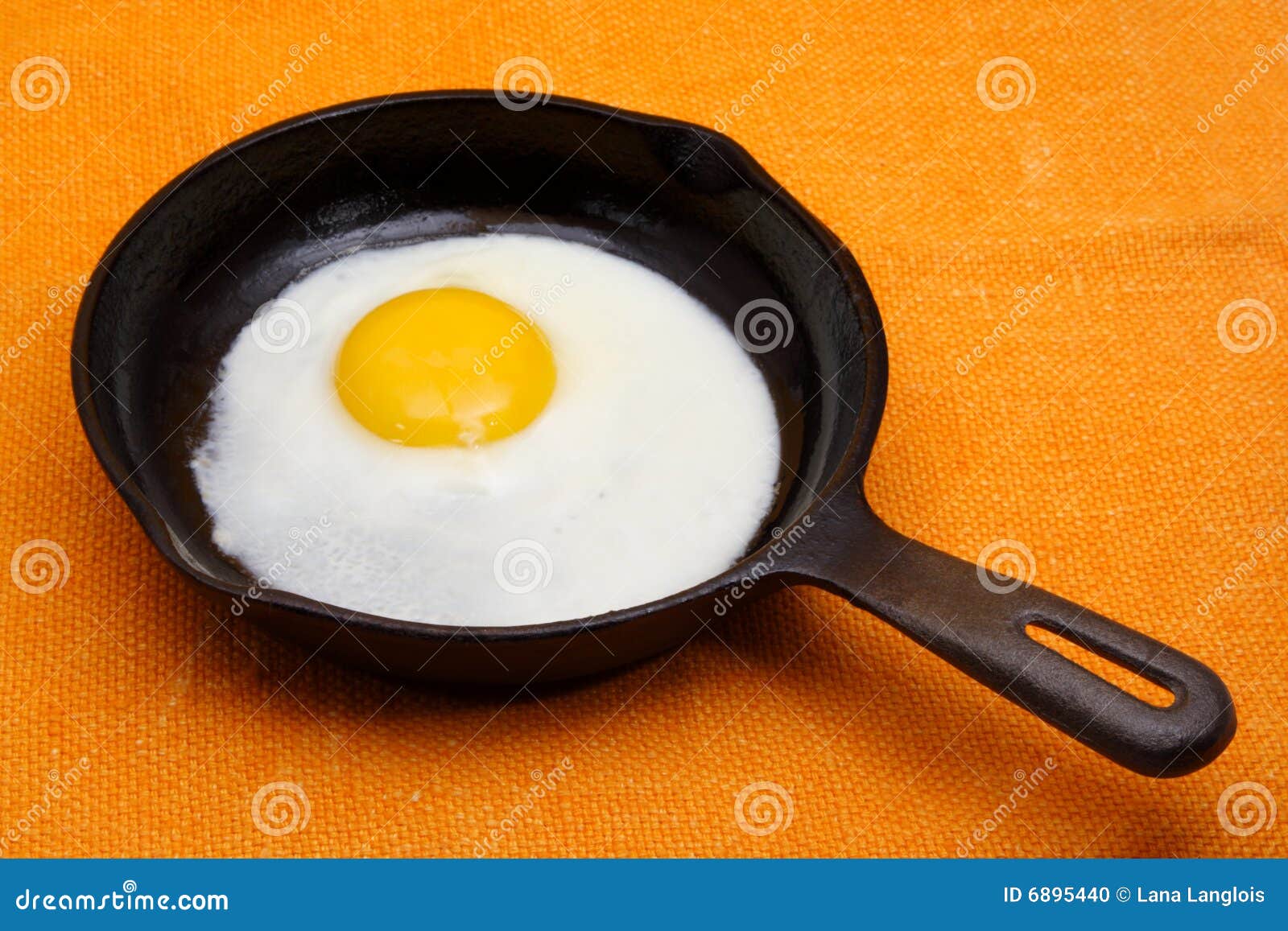 Egg in a cast iron pan stock photo. Image of tablecloth 6895440