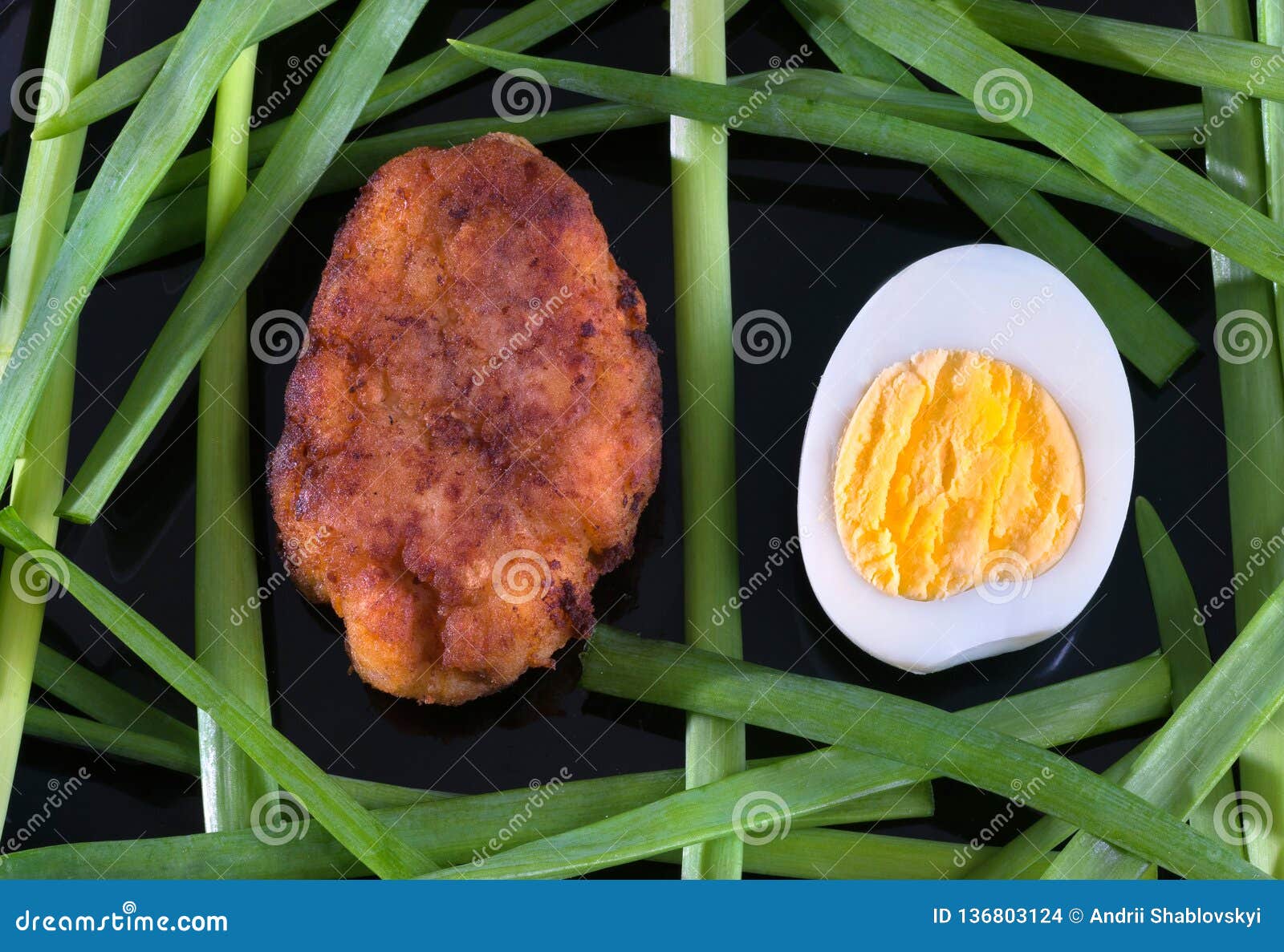 Egg, Chop And Lettuce On A Black Background, Closeup Stock Photo