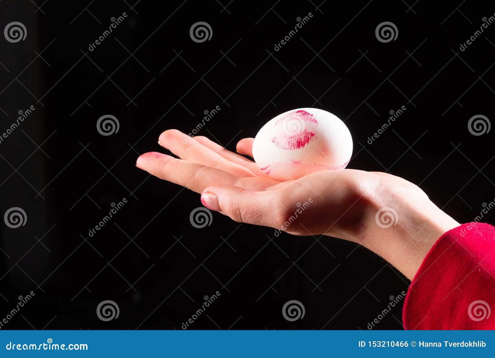 Egg in Hand. Imprint of the Lips, Womens Lipstick on the