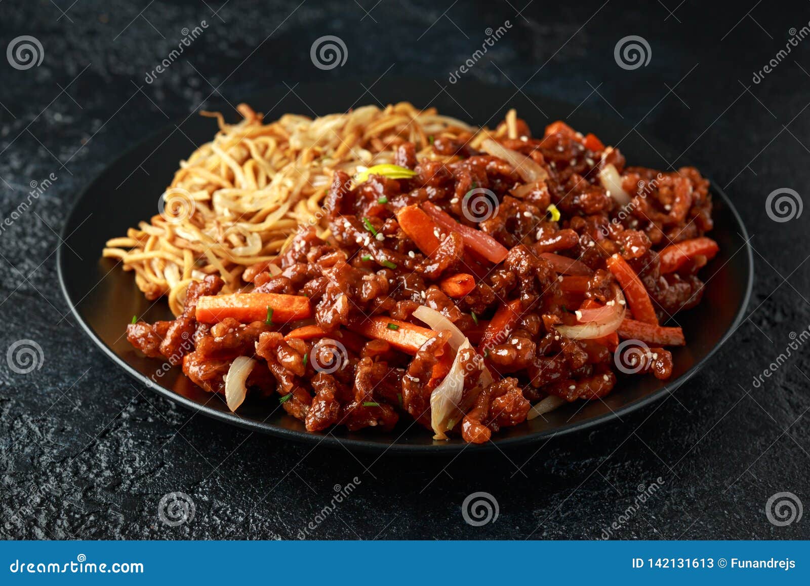 Egg Noodles with Bean Sprouts and Crispy Shredded Beef on Black Plate