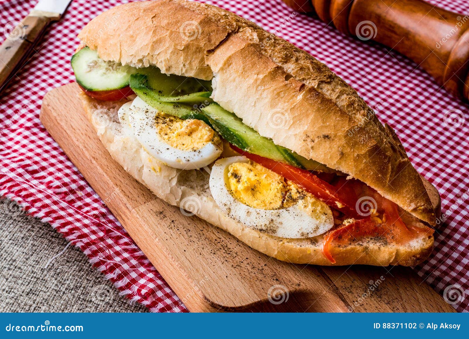 Egg Sandwich with Black Pepper, Tomatoes and Greens. Stock Photo
