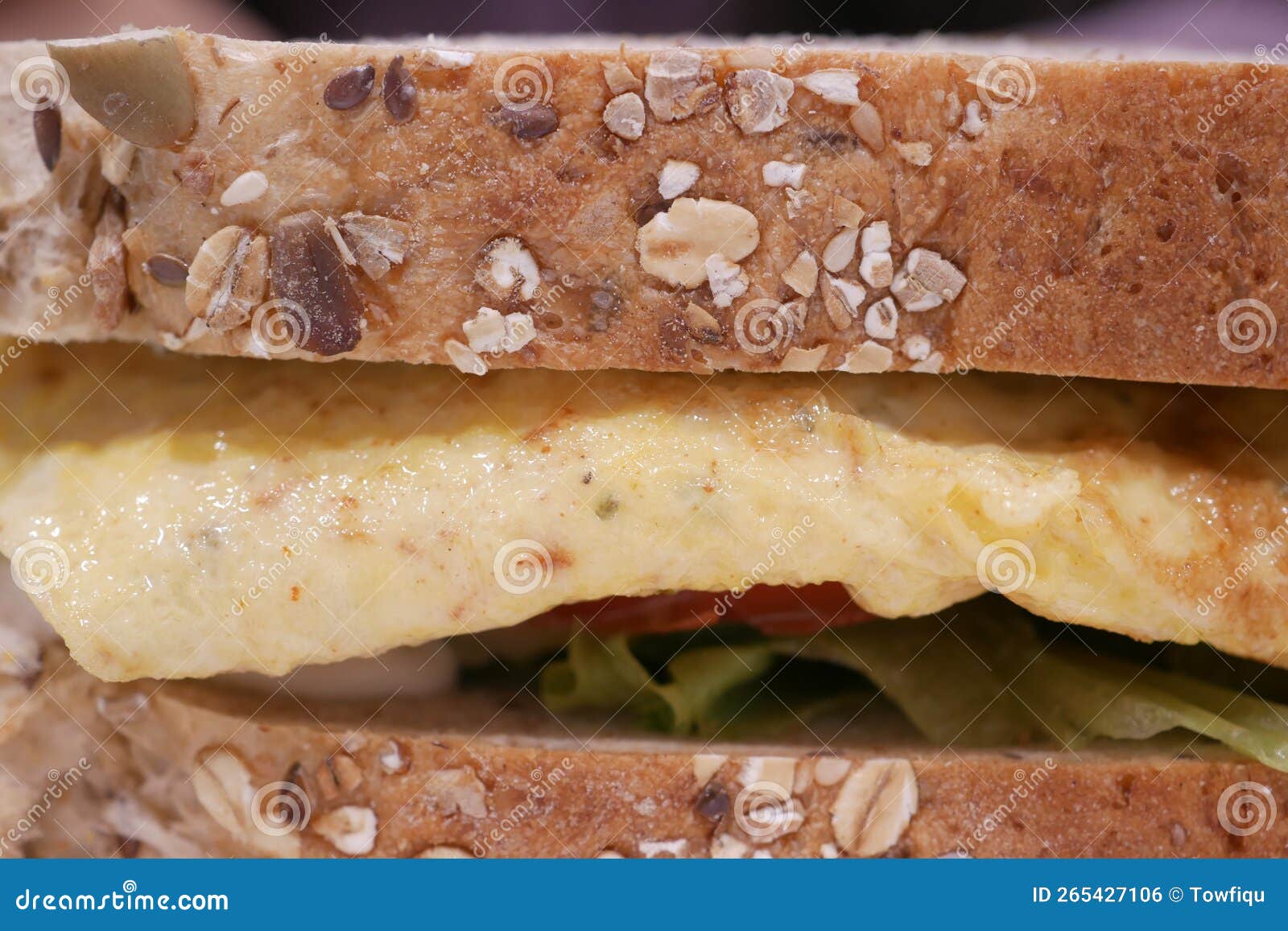 Egg Sandwich Made with Brown Bread, Tomato and Lettuce on Table Stock