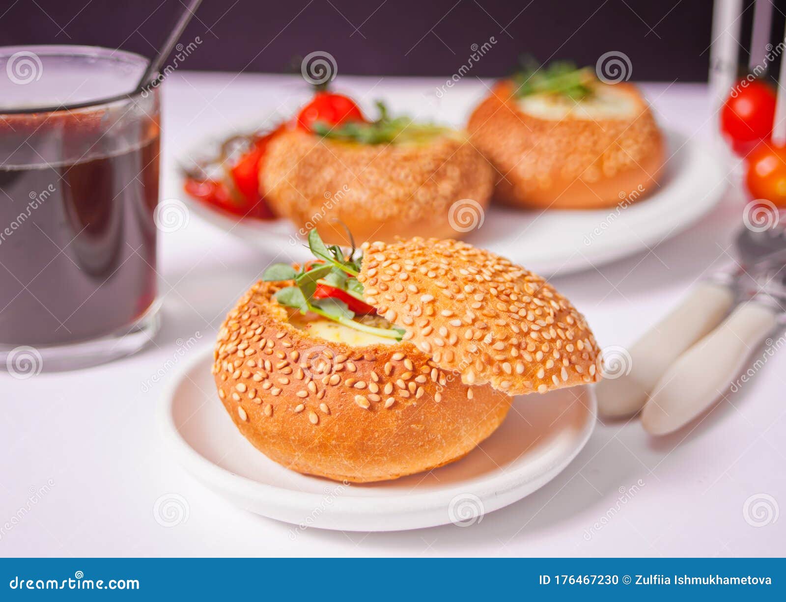 Egg Served in Bread Bowl. Breakfast Baked Eggs in Bread Bowls with the Fresh Herbs Stock Photo