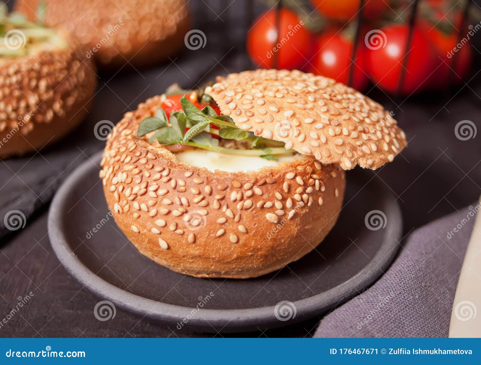 Egg Served in Bread Bowl. Breakfast Baked Eggs in Bread Bowls with the Fresh Herbs Stock Image