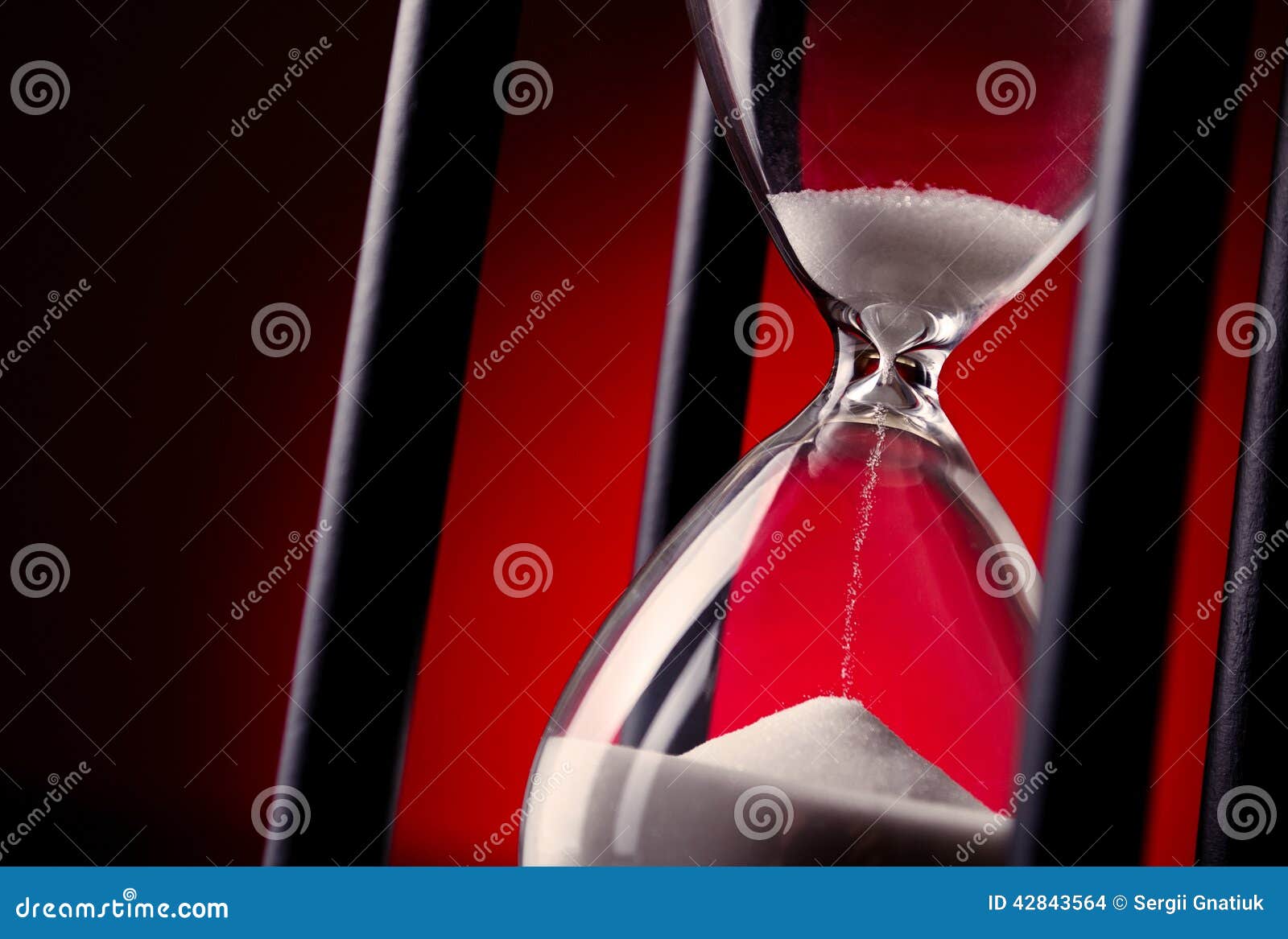 egg timer or hourglass on a red background