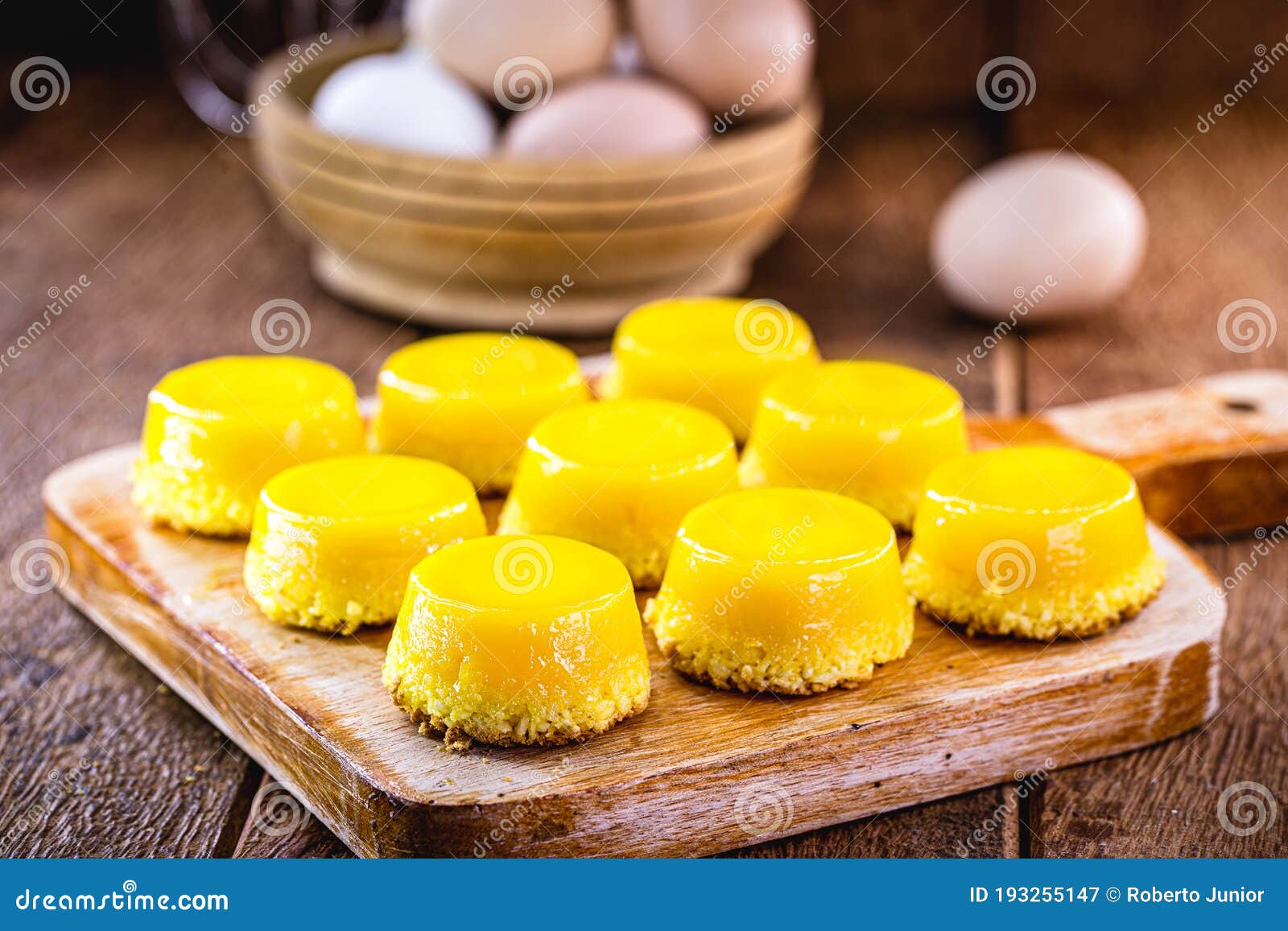 egg yolk candy, called quindim in brazil, and portugal in brisa-do-lis. sweet dessert on rustic wooden background