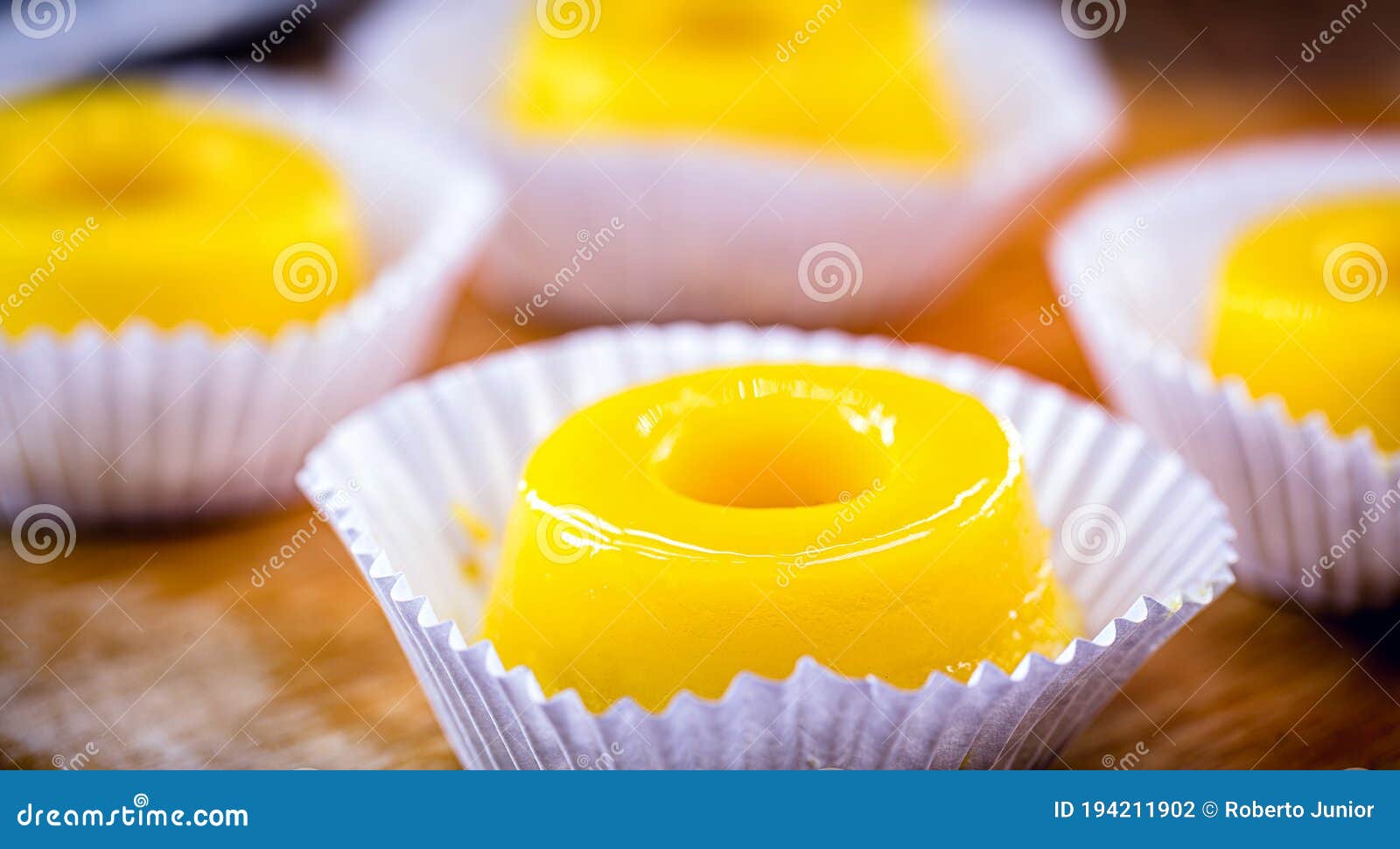 egg yolk candy, called quindim in brazil, and portugal in brisa-do-lis. sweet dessert on rustic wooden background
