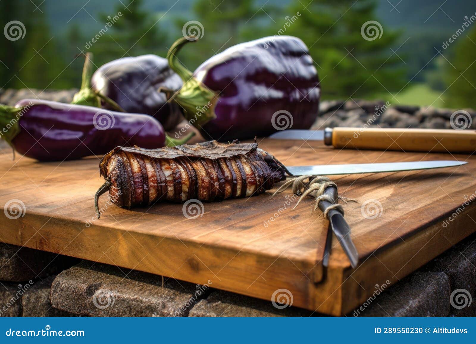 Eggplant on Cedar Plank, Grilling Tools in Background Stock Photo
