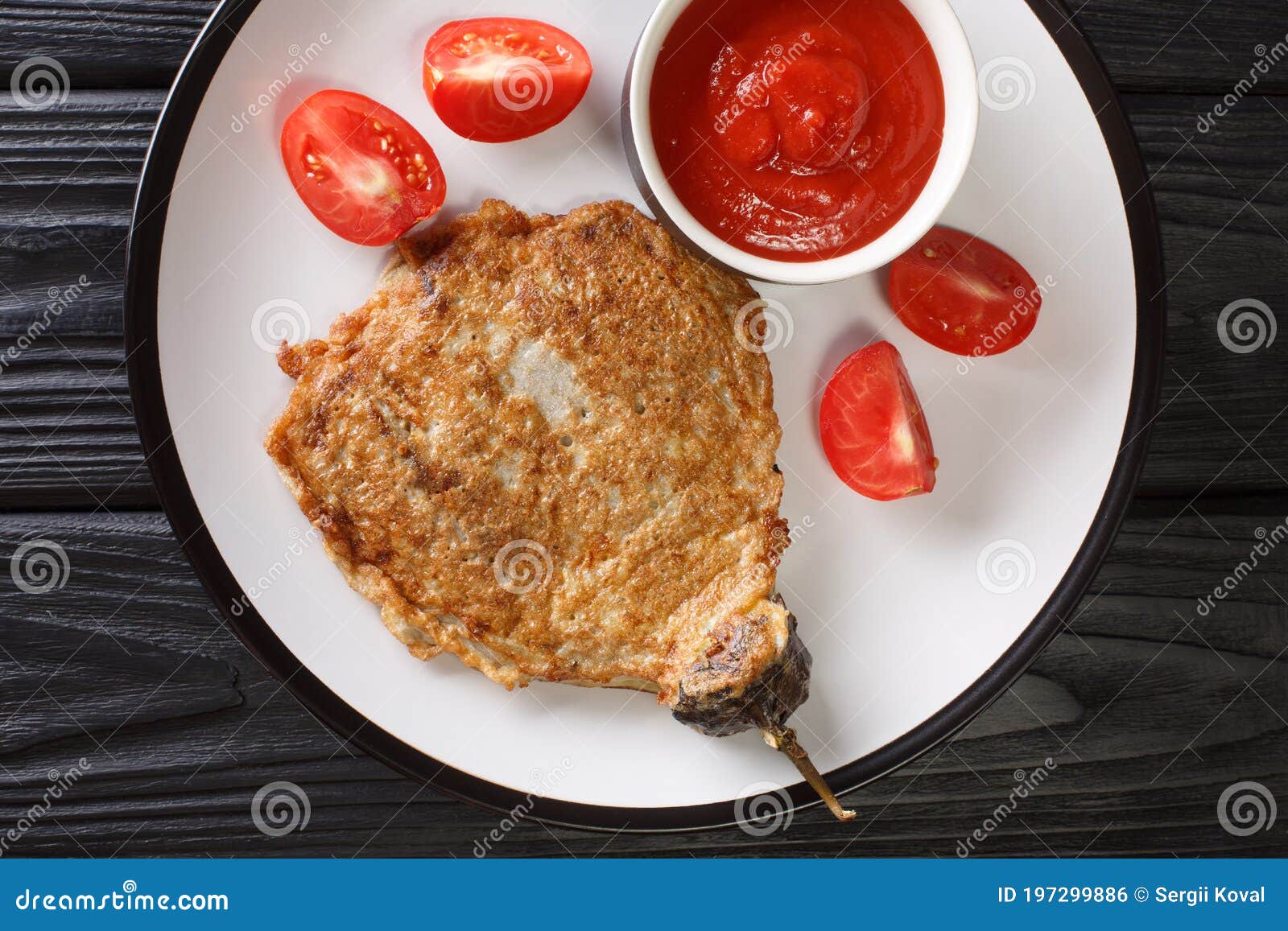 eggplant omelet tortang talong served with ketchup close-up on a plate. horizontal top view