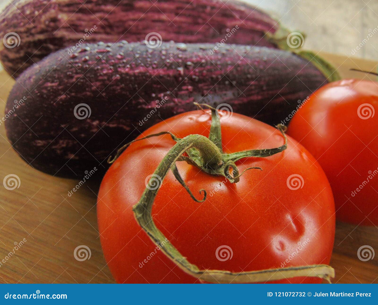 Eggplants with Tomatoes on a Wooden Table. Stock Photo Image of