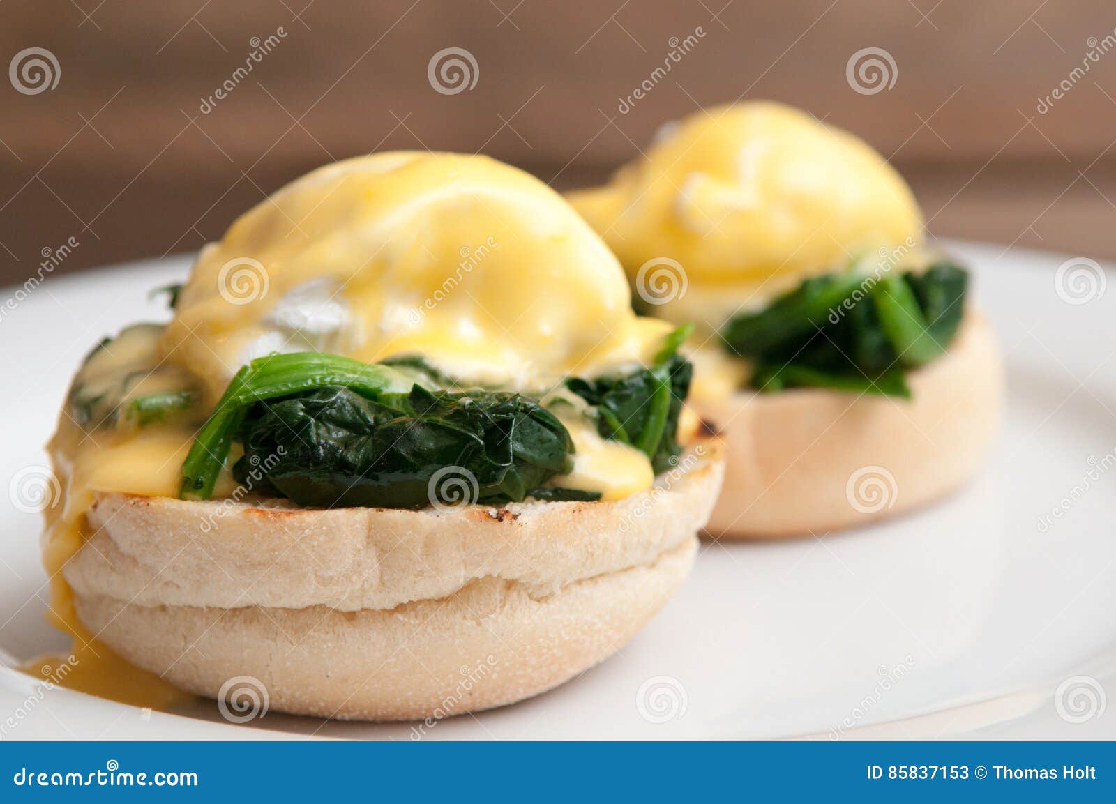 eggs benedict or eggs florentine on a white plate in the cafe