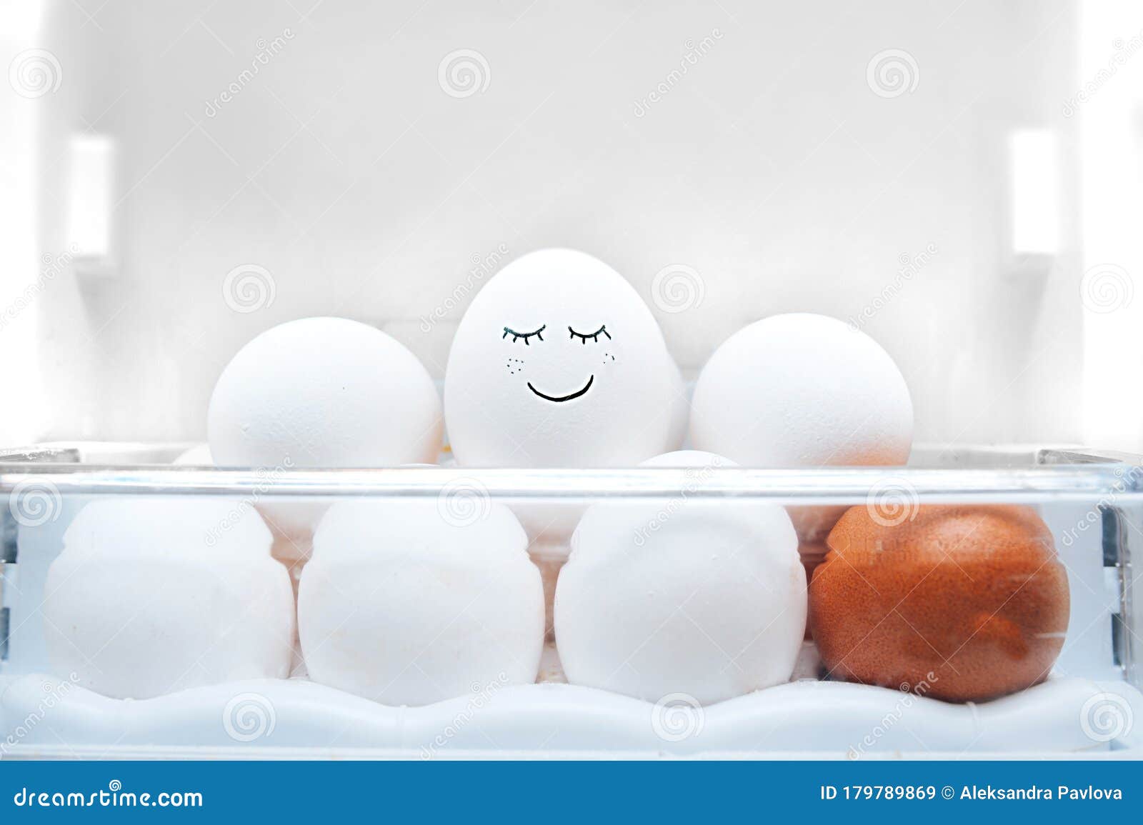 Eggs in the Refrigerator. a White Easter Egg with Painted Happy Face on Other Clean Eggs in the