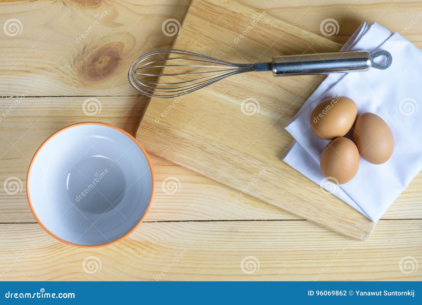 eggs with whisk and empty ornage bowl