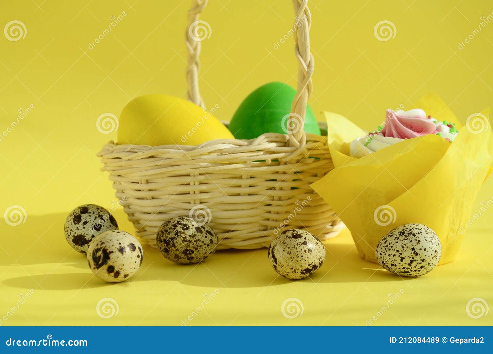 Eggs in White Wicker Basket and Quail Eggs , Easter Cake on Yellow