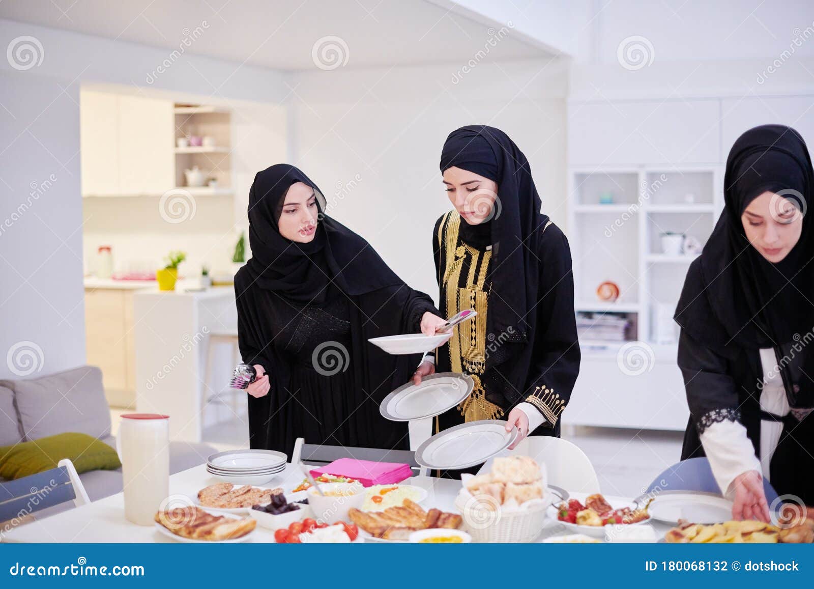 Young Muslim Girls Serving Food on the Table for Iftar Dinner ...