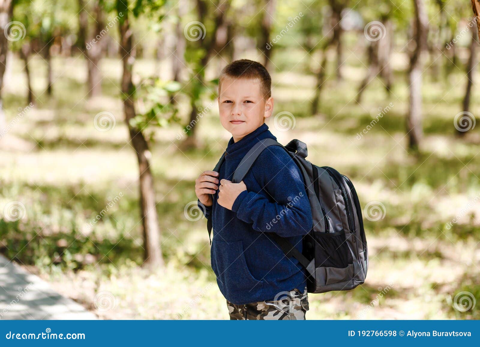 Eightyearold Schoolboy with a Large Backpack Stock Photo Image of