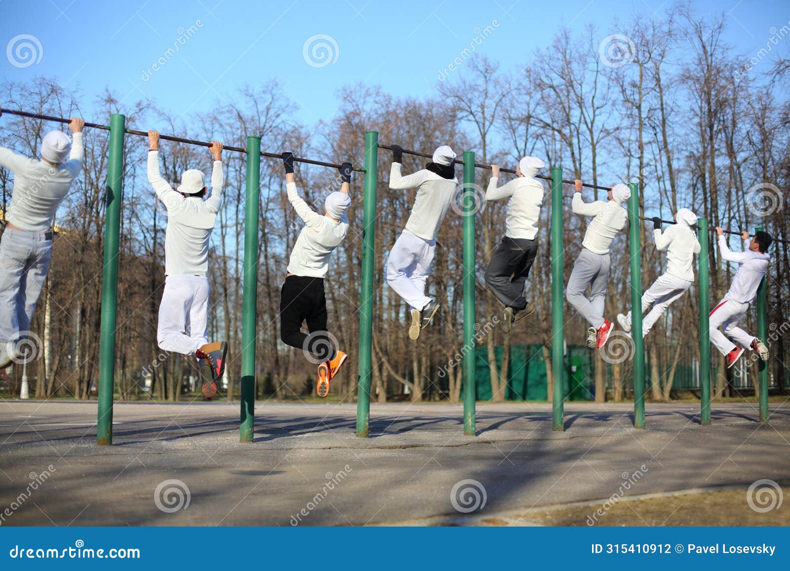 eight young men coaching on the horizontal bar on