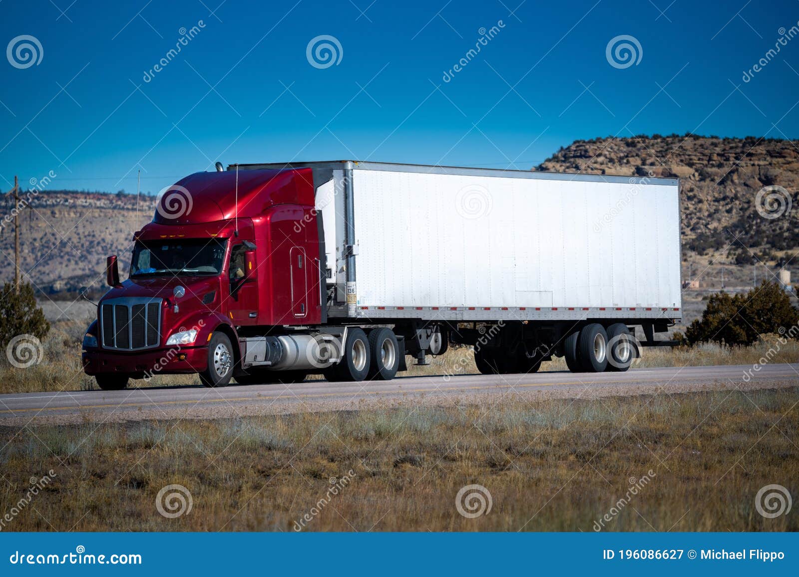 eighteen wheel big rig tractor with trailer on highway. trucking industry