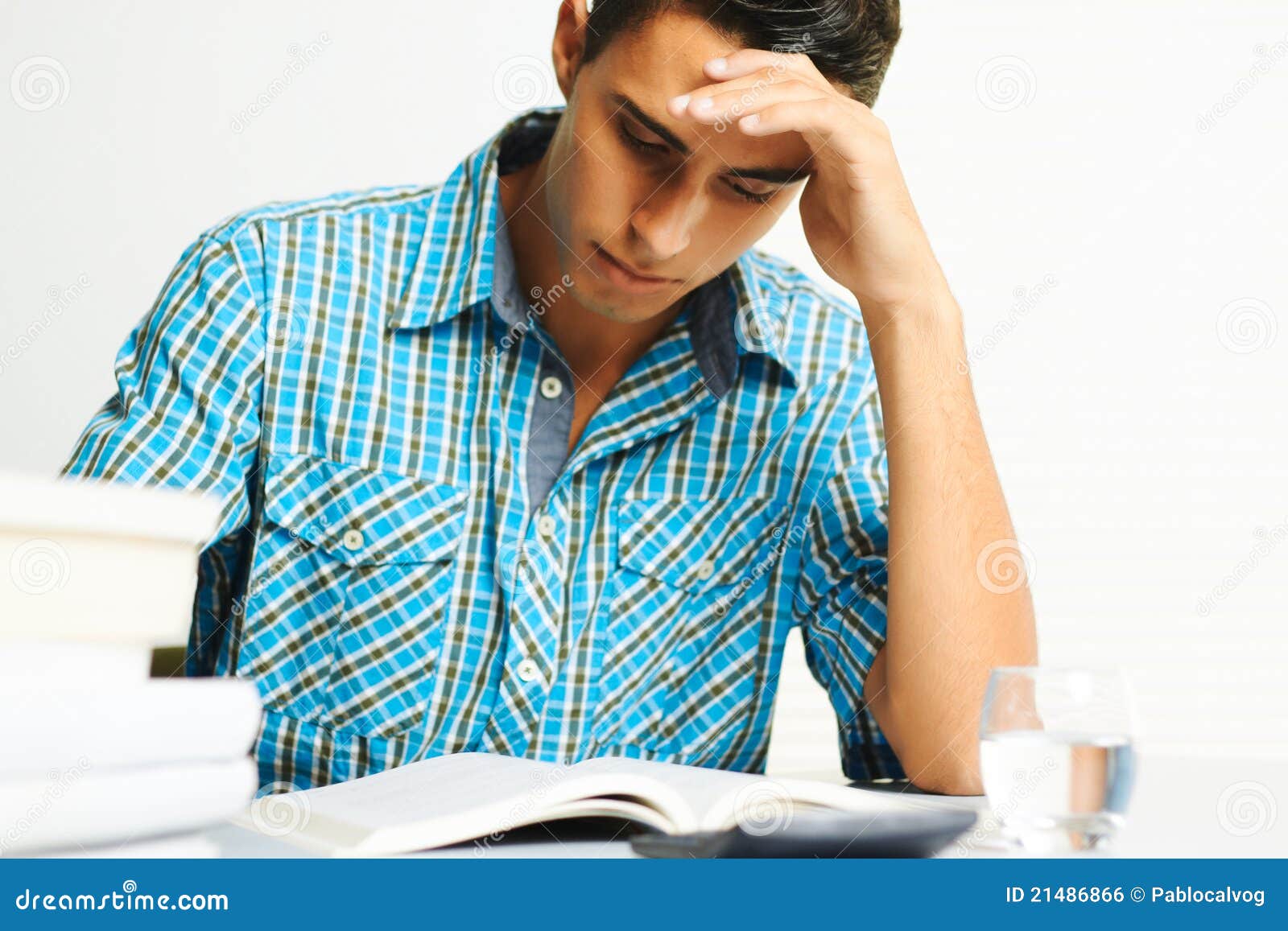 El concentrar del hombre joven. Hombre joven que concentra mientras que lee un libro.