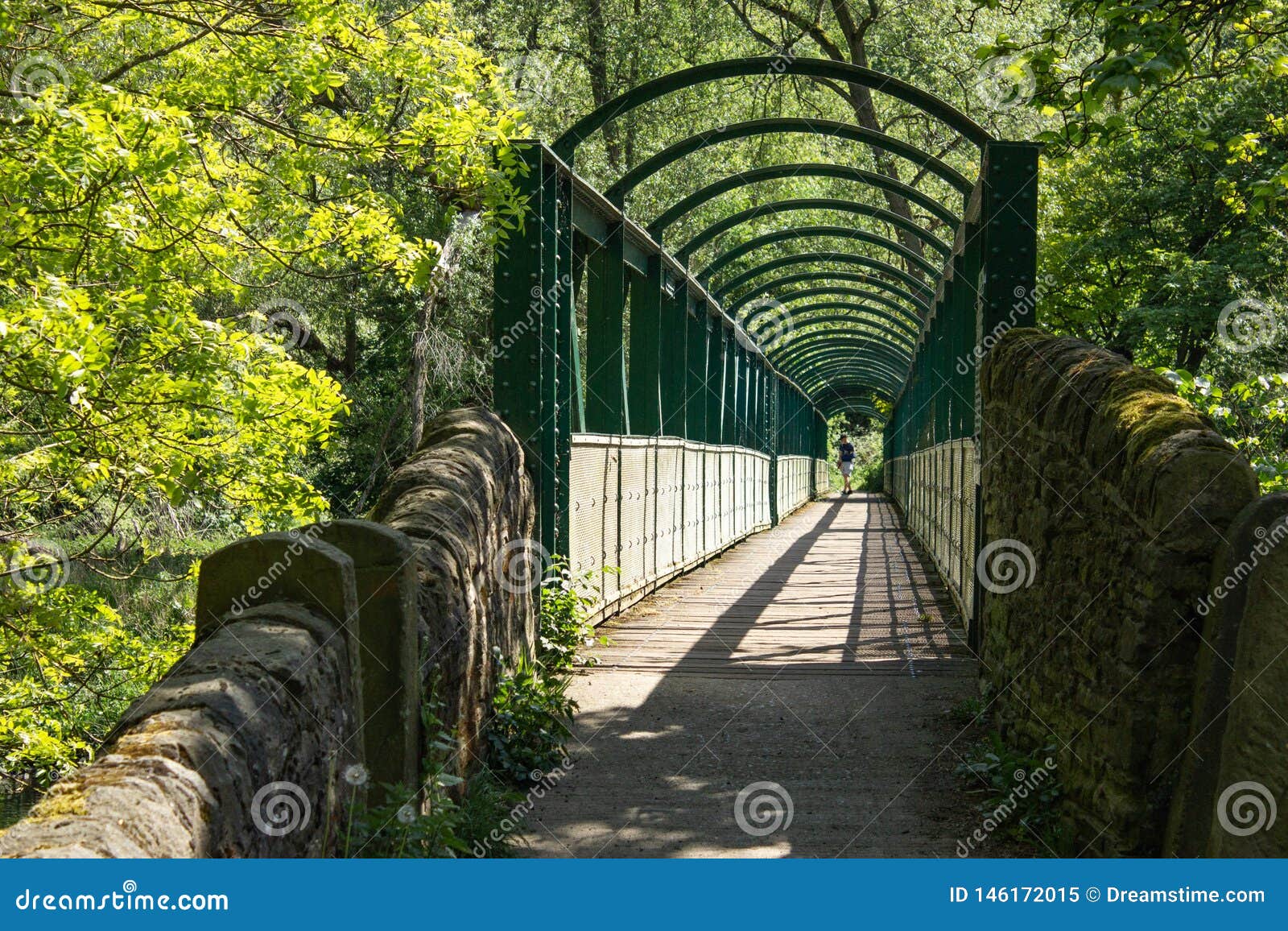 El llevar a una nueva perspectiva. Un puente del hierro a través del río Aire en Yorkshire tienta al caminante para tomar una nueva dirección para ver cuál está en el otro lado