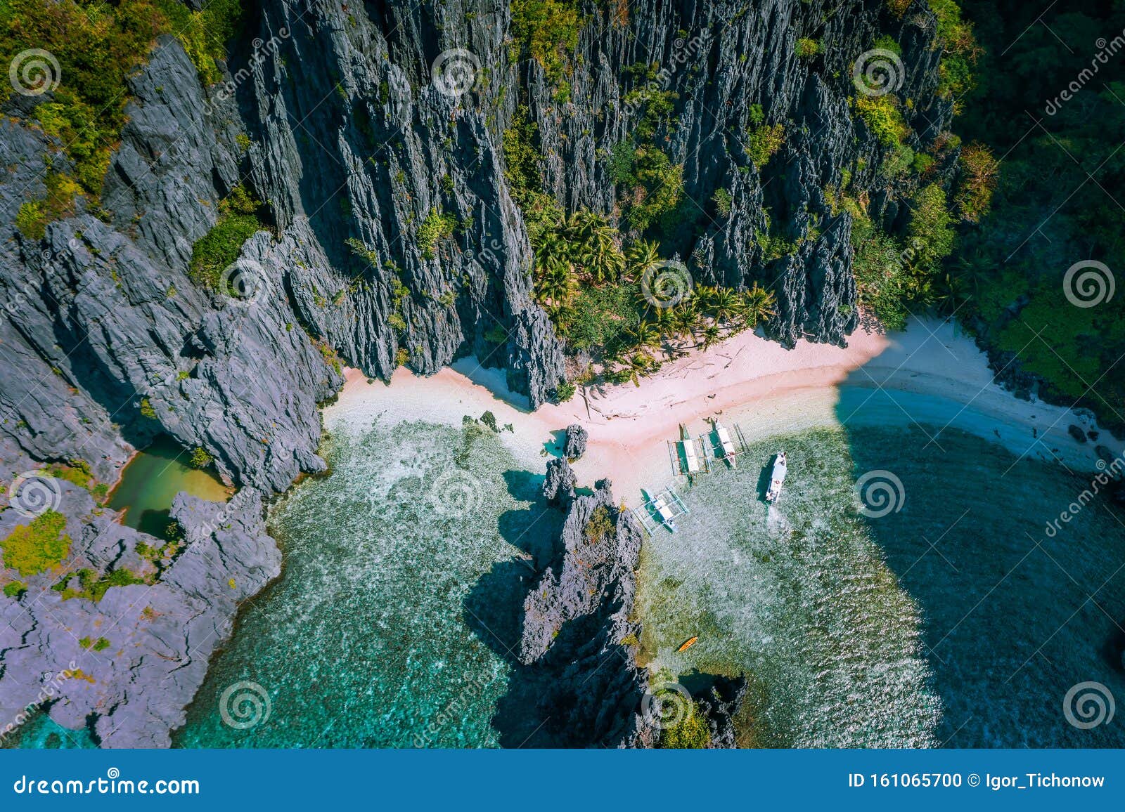 el nido, palawan, philippines. aerial view of secret hidden lagoon beach with tourist banca boats on island hopping tour