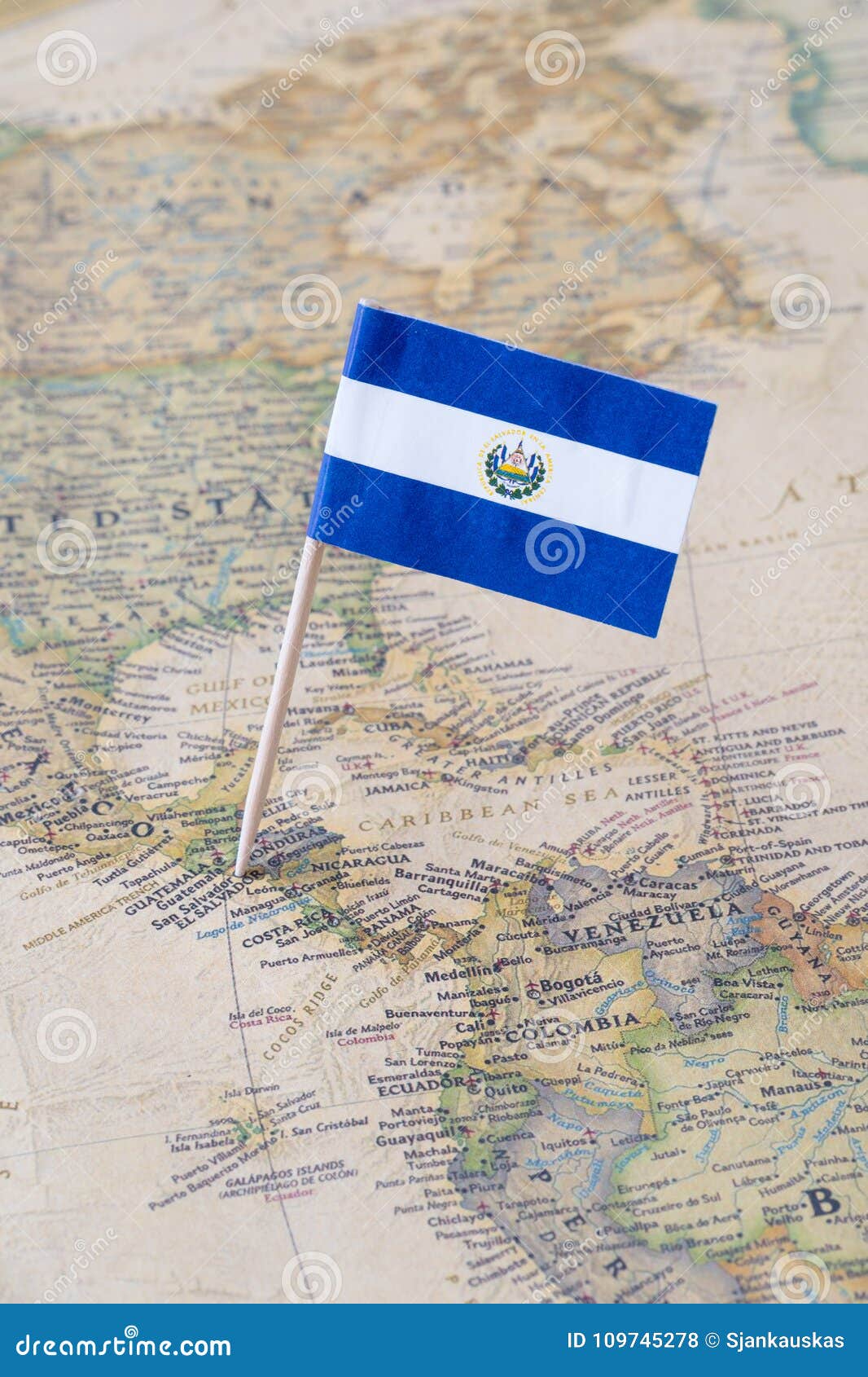 el salvador flag pin on a world map