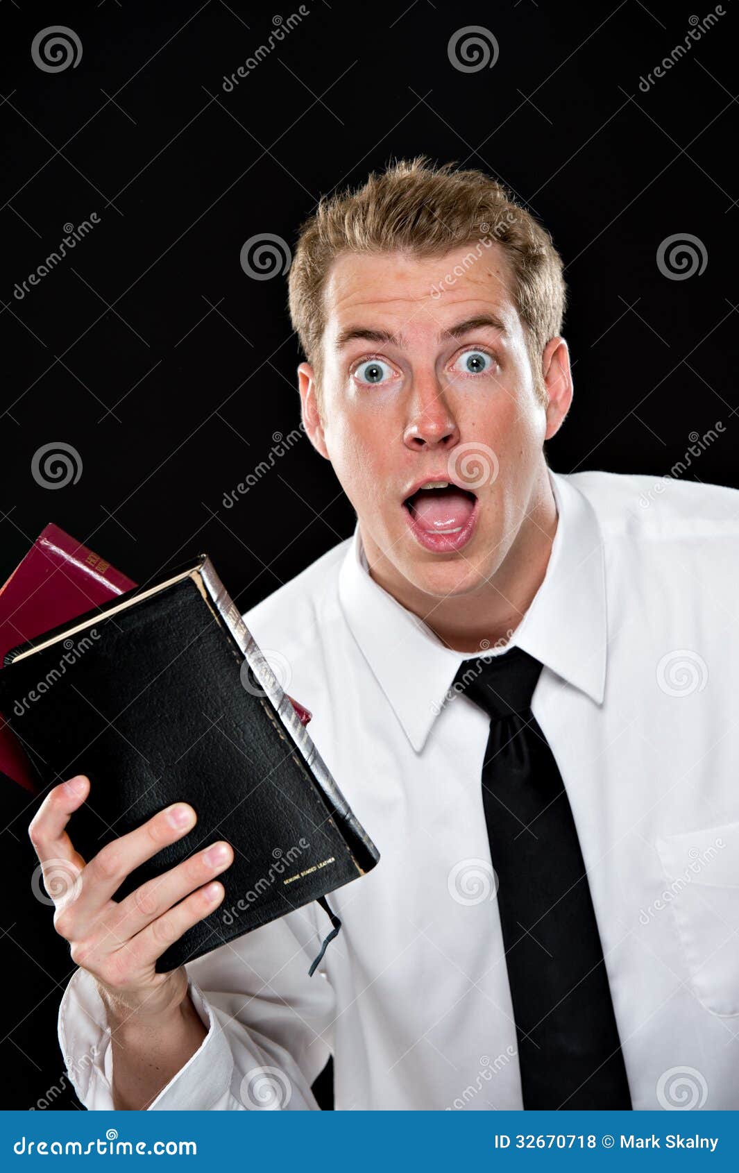 Elated Young Man Holding Bibles Stock Photo Image of 