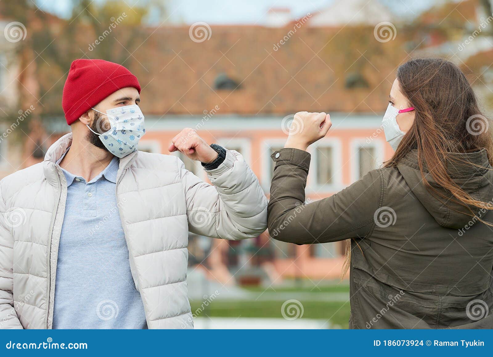 Friends in Medical Face Masks Bump Elbows instead of Greeting with a ...