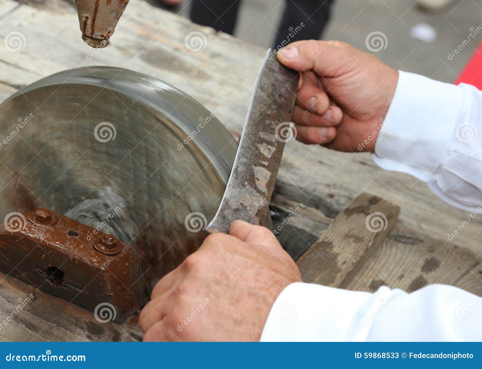Elder while Sharpening the Blade of the Knife on the Large Water Stock