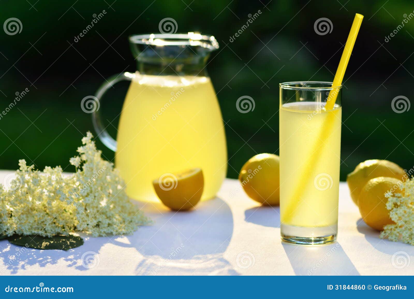 elderflower juice with lemon on table in a garden