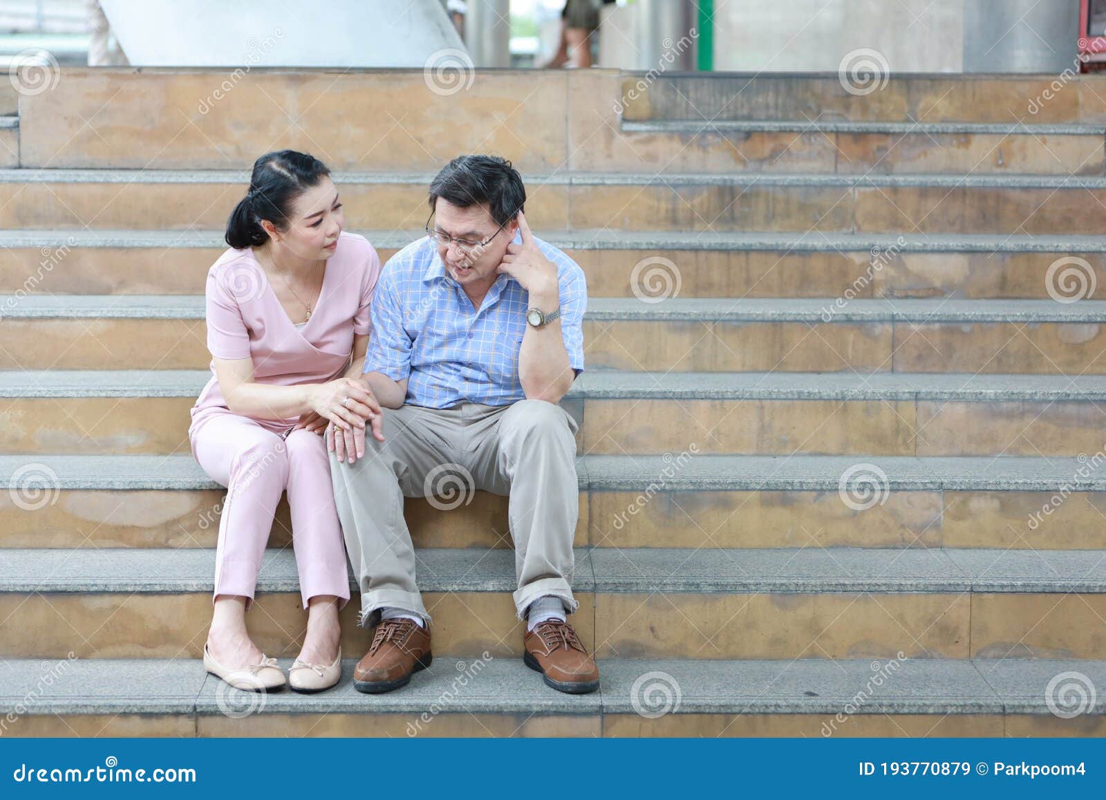 Elderly Asian Wife Is Comforting Elder Asian Husband And Put Her Hand