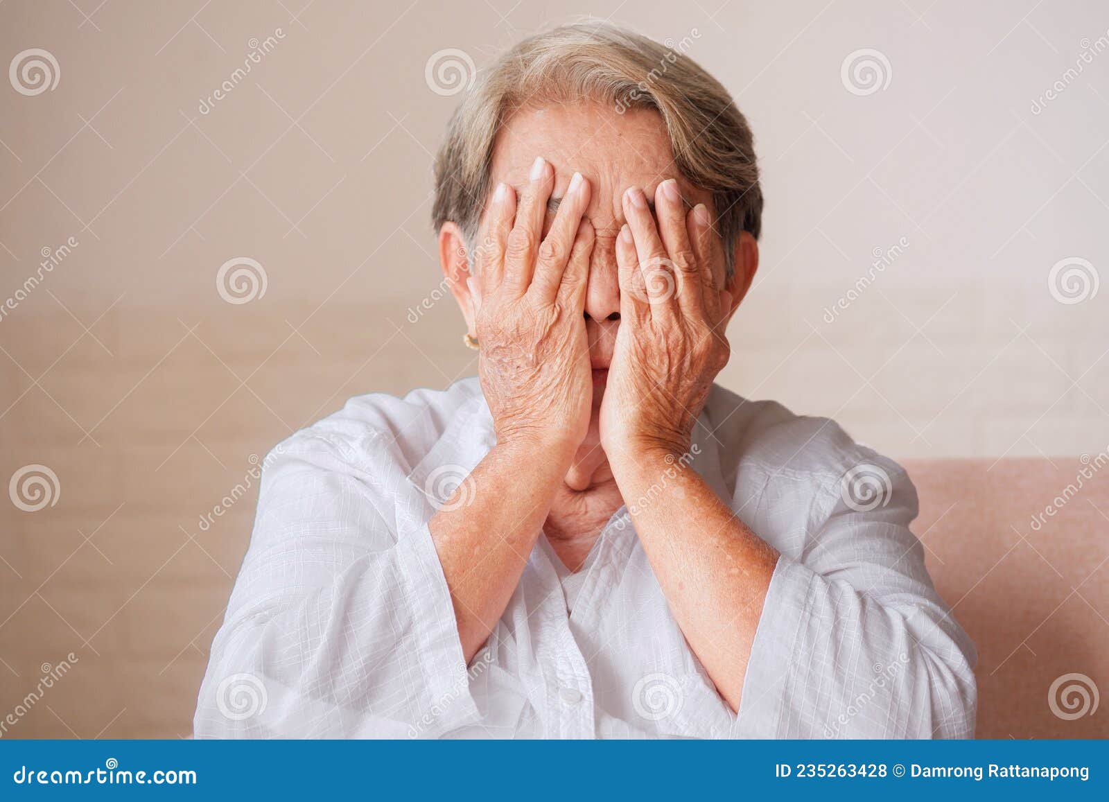 elderly asian woman with gray hair covering both eyes with hands, blindness, cataracts, pterygium, eye disease concept