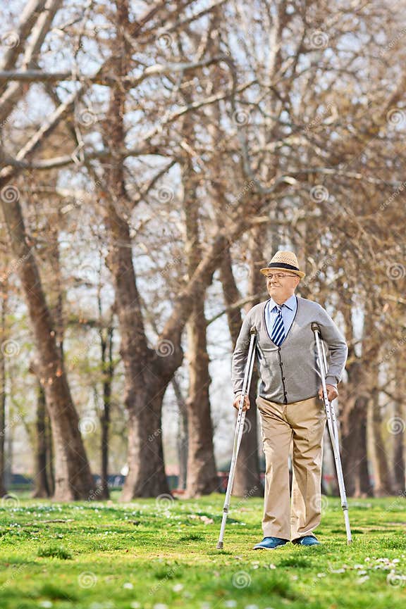 Elderly Gentleman Walking with Crutches Outdoors Stock Image Image of