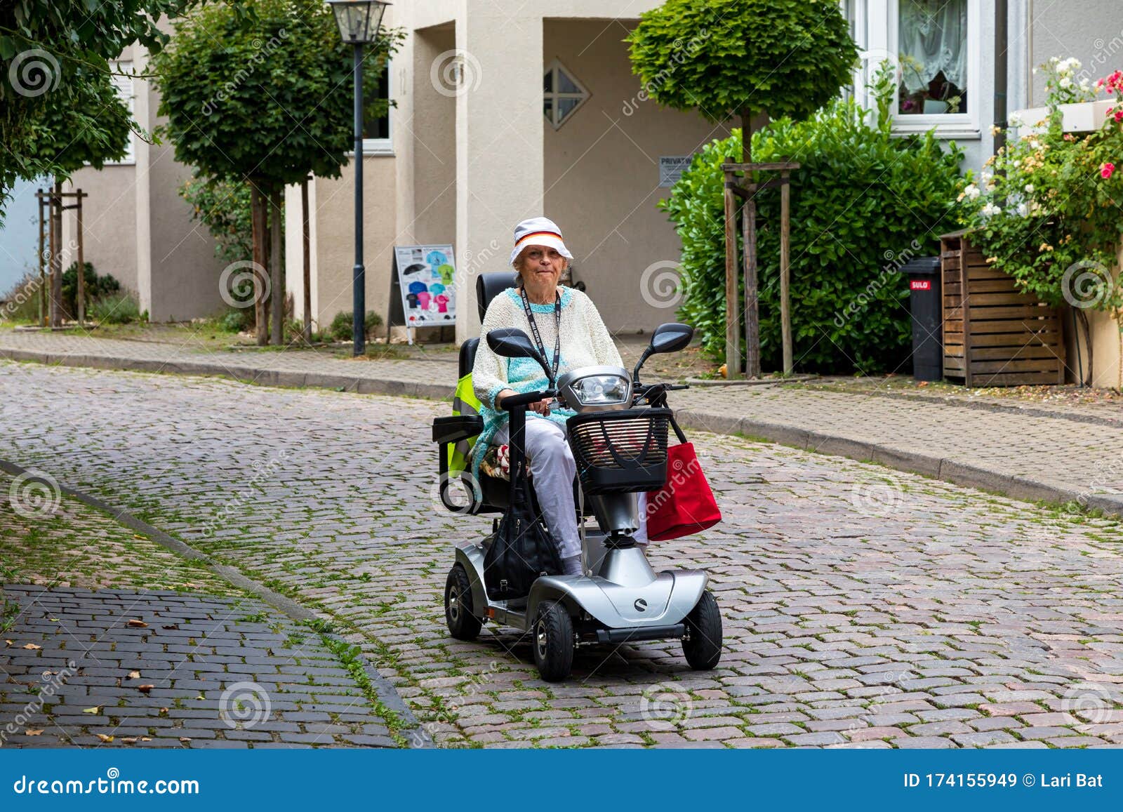 An Happy Lady Rides a Four-wheeled Electric Scooter for the Disabled on the Street of the Old German City. Image of Active Editorial Stock Image - Image of adult, 6069: 174155949