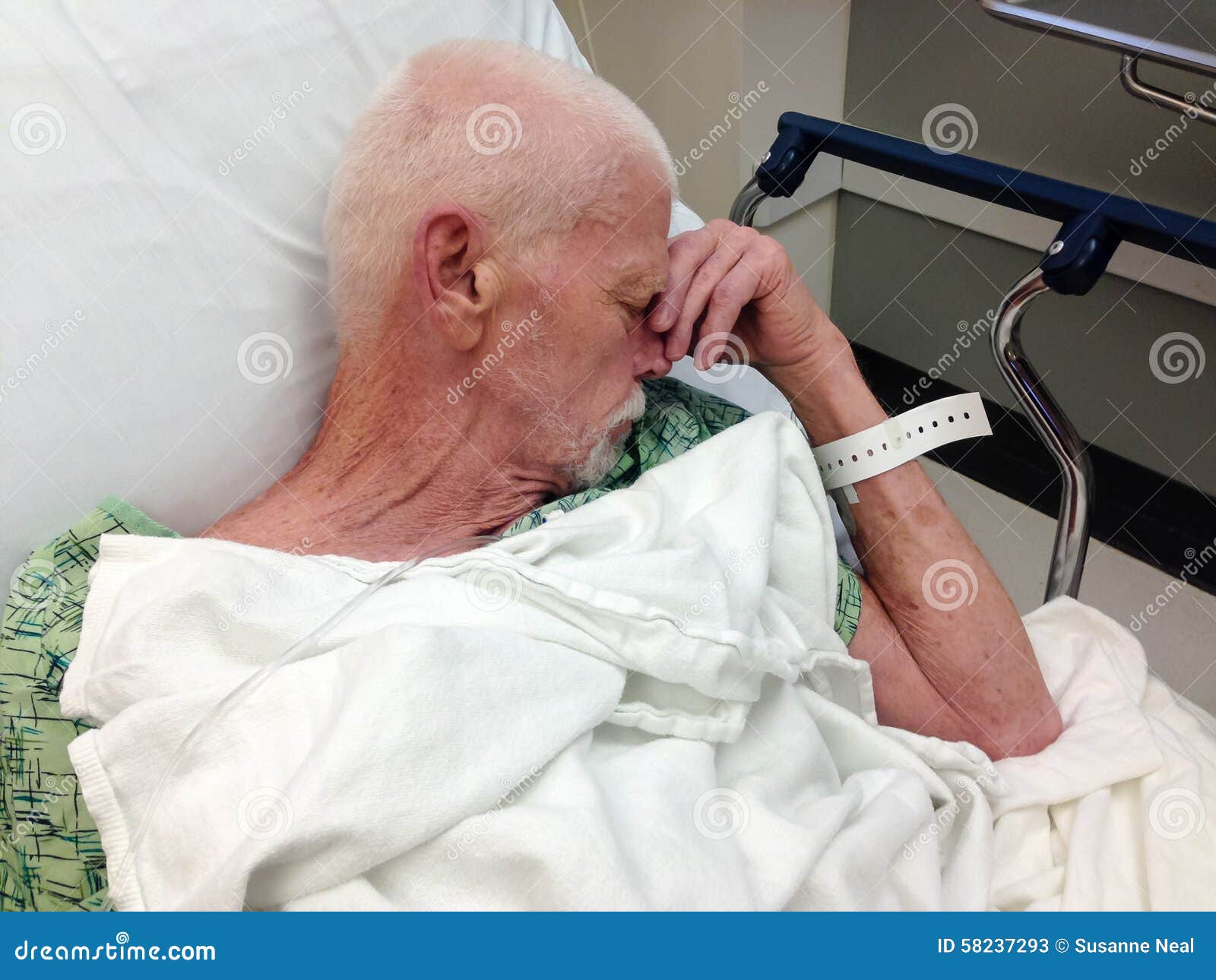 elderly male hospital patient in hospital bed