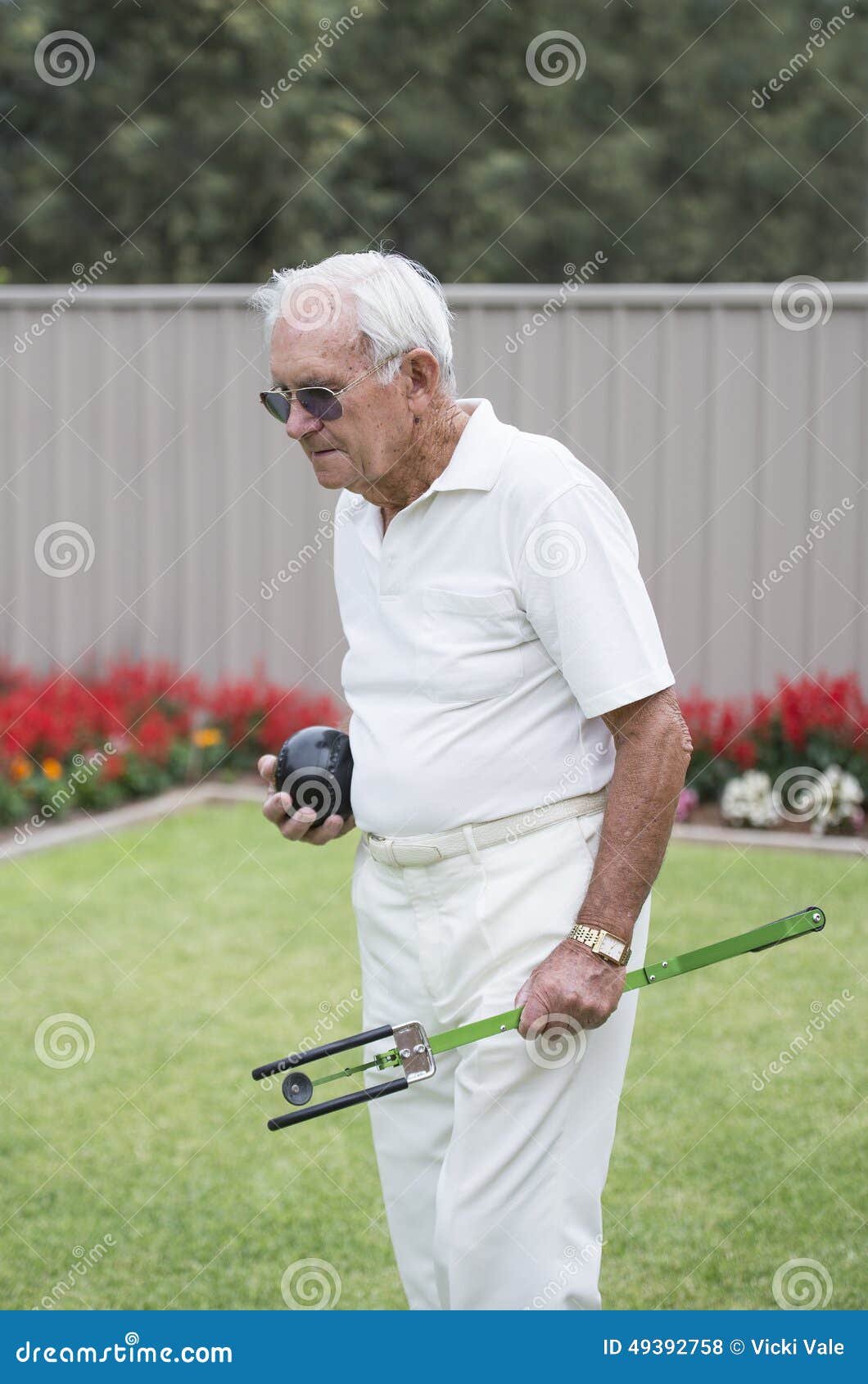 Elderly Man Carrying Artificial Bowling Arm and Ball. Stock Photo